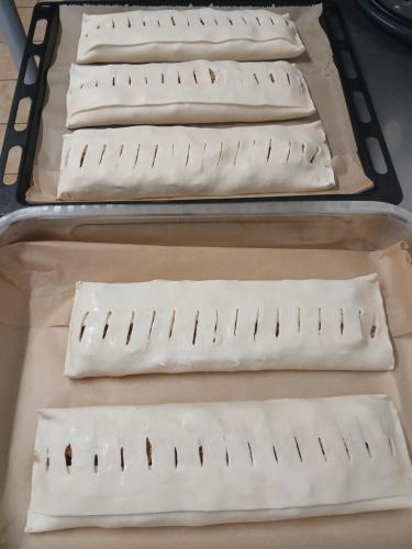 three baking pans with uncooked pizzas on them at Landgasthof zum SEEHOF in Rottweil