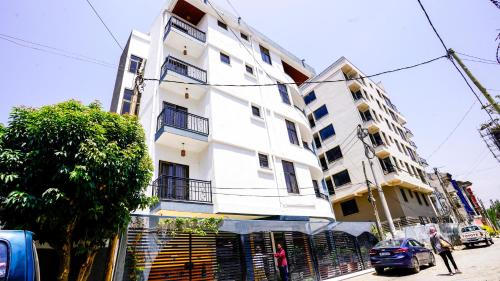 a white building on the side of a street at Brighton Guest House and Cafe in Addis Ababa