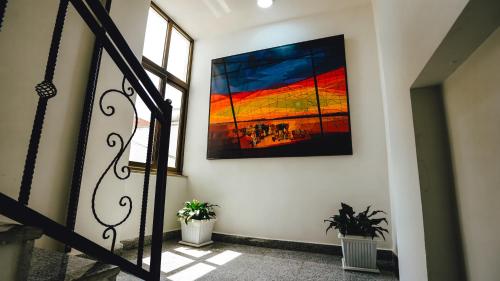 a painting of a sunset on a wall at Brighton Guest House and Cafe in Addis Ababa