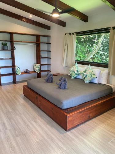 a bedroom with a large bed in a room at Roam Yoga & Wellness Lodge in Bocas del Toro
