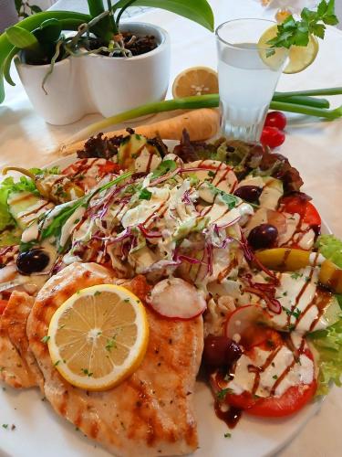 a plate of food with fish and a salad at Landgasthof zum SEEHOF in Rottweil
