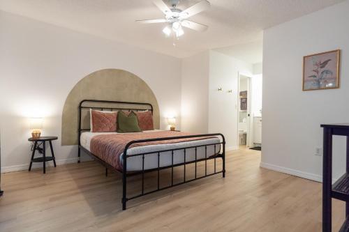 a bedroom with a bed and a ceiling fan at Private Tropical Beach Oasis - Aloe in Cape Canaveral