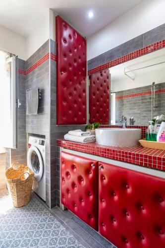 a bathroom with a sink and a washing machine at Artist Loft in Corfu