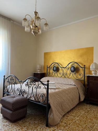 a bedroom with a bed and a chandelier at appartamento Il Galletto in Vitiano