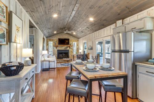 a kitchen with a table and a refrigerator at 3 Mi to Dtwn Blue Ridge Cabin with Hot Tub and Views in Blue Ridge