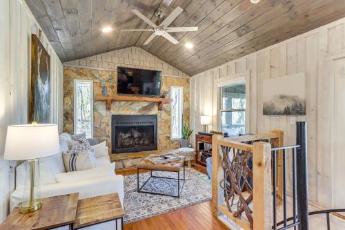 a living room with a fireplace and wooden ceilings at 3 Mi to Dtwn Blue Ridge Cabin with Hot Tub and Views in Blue Ridge