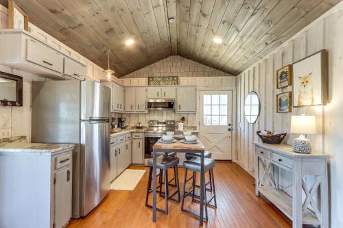 a kitchen with a stainless steel refrigerator and stools at 3 Mi to Dtwn Blue Ridge Cabin with Hot Tub and Views in Blue Ridge