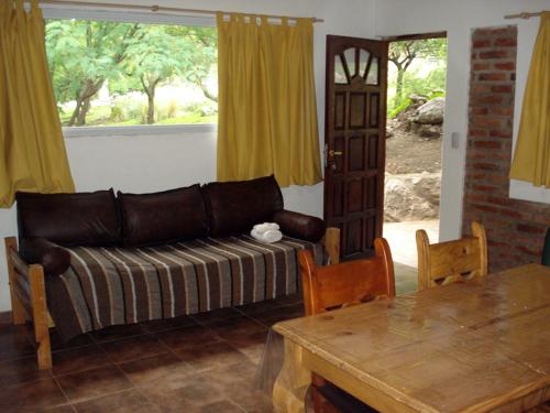 a living room with a couch and a table at Cabañas Buena Vista in Los Cocos