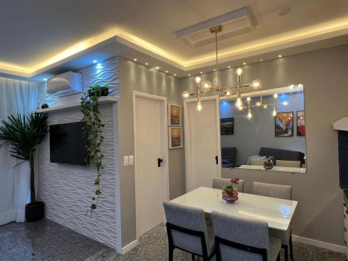 a dining room with a white table and chairs at Saint Martin Flat Fortaleza in Fortaleza