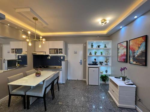 a kitchen and dining room with a table and chairs at Saint Martin Flat Fortaleza in Fortaleza