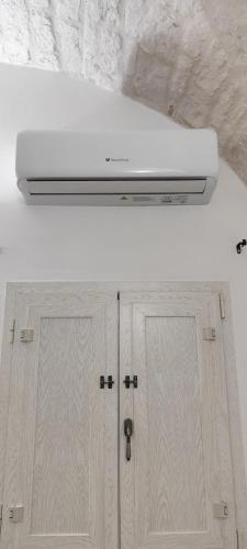 a white overhead light above a kitchen cabinet at Borgo Diaz in Cisternino