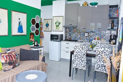 a kitchen and living room with a couch and a table at Rigoletto Cilento with private garden and pool in Eredita