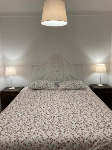 a bedroom with a large bed with two night stands at Casa Jacintos - Sintra, Magoito in Bolembre de Baixo
