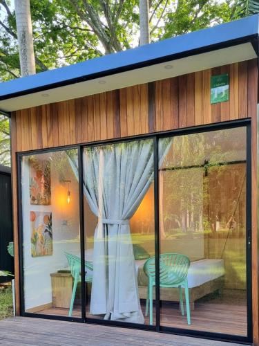 a tiny house with a window and a bench at HOTEL SANTAFE NATURA - SANTAFE DE ANTIQUIA in Santa Fe de Antioquia
