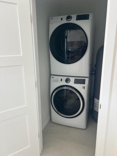 a washer and dryer sitting next to each other at Jolly Rancher Exuma 5 bed 6 bath multi family in Georgetown