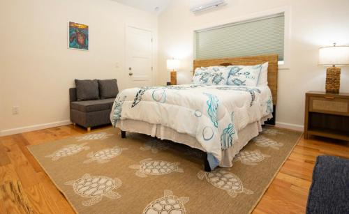 a bedroom with a bed and a couch and a chair at Jolly Rancher Exuma 5 bed 6 bath multi family in Georgetown