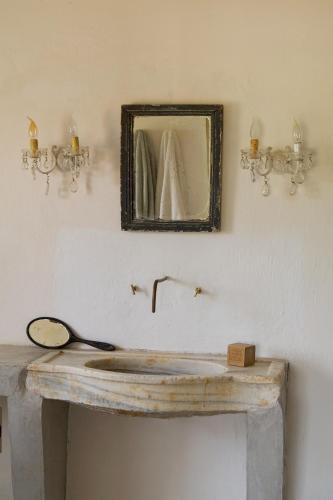 une salle de bain avec un lavabo en bois et un miroir dans l'établissement La Grande Bastide, à Vaugines