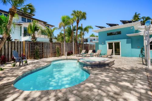 a backyard with a swimming pool and a house at The Ringling Beach House in Siesta Key