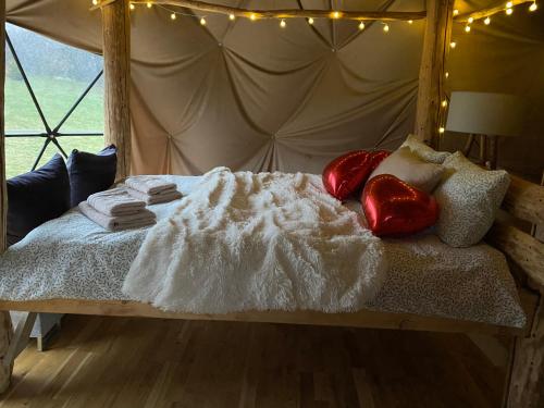 a bed with blankets and pillows with lights on it at Lepiej trafić nie mogliście in Mieroszów