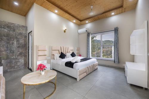 a bedroom with a bed and a table and a window at The Mesmerizing Villa I Kufri I Nature Walk I Family Events & Bonfire I Memories & Enjoyment Villa I Operated by Exotic Stays in Kūfrī