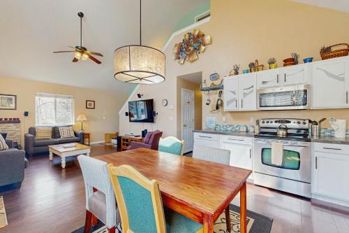 a kitchen and living room with a wooden table and chairs at Gunni Getaway in Gunnison