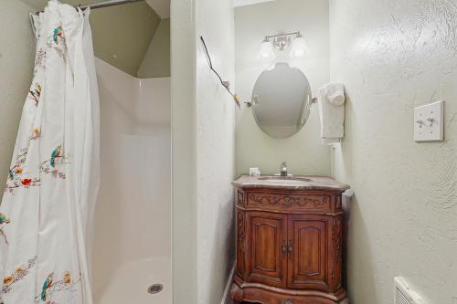 a bathroom with a wooden sink and a mirror at Gunni Getaway in Gunnison