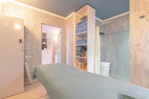 a room with a bed and a glass door at Passage Antique Hotel in Baku