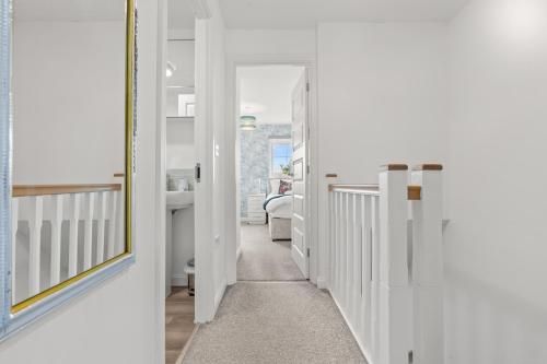 a hallway with white walls and a mirror at Black Friday Deal - Stunning 2BR House with Garden, Netflix Walk 30min to Alton Tower in Stoke on Trent