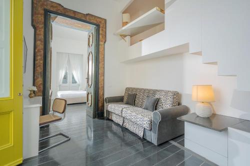 a living room with a couch and a chair at Hotel Palazzo Murat in Positano