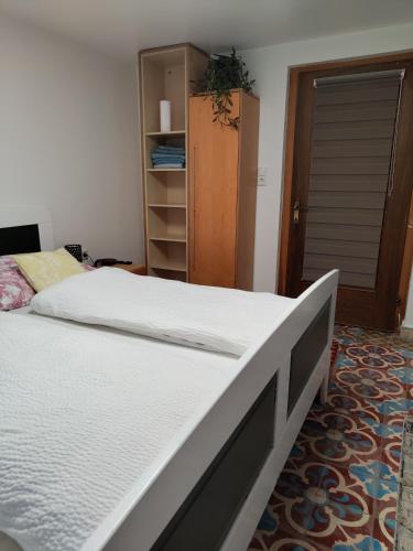 a bedroom with a large bed and a closet at Doppelzimmer mit Gemeinschaftsbad und kleiner Küche Nannen 382 in Alberschwende