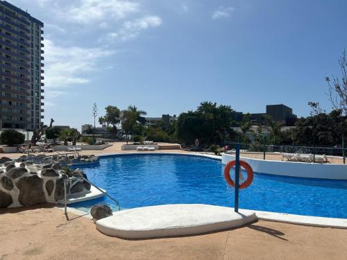 a swimming pool with a no swimming sign next to it at Mirador Paraiso in Adeje