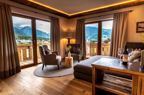 a living room with a view of a mountain at Hotel Spielmann in Ehrwald