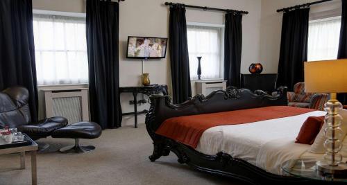 a bedroom with a bed and a table and chairs at Aston Hall Hotel, BW Signature Collection in Sheffield