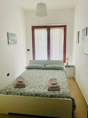 a bedroom with a bed with two towels on it at Casa Adele in Salerno