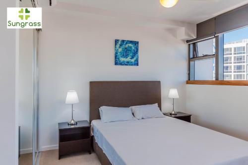 a bedroom with a large bed and a window at Fleet Lane Apartments in Brisbane