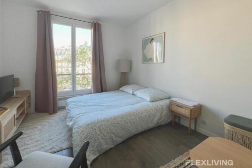 une chambre avec un lit et une fenêtre dans l'établissement Flexliving - Studio - Patriarches, à Paris