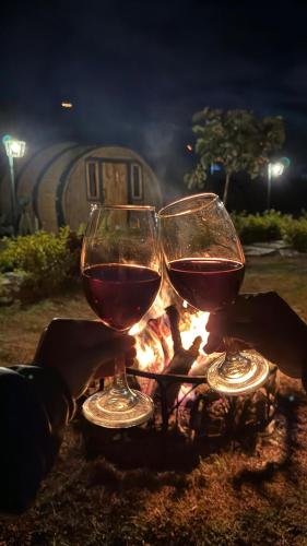 two glasses of wine sitting next to a fire at Aldea Fuquenense in Fúquene