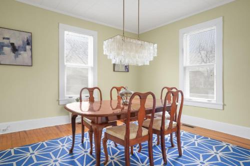 a dining room with a table and chairs at Maison des Reves - Historic charm in the heart of Downtown! in Cape Charles