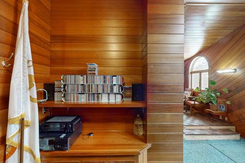 a room with wooden walls and a shelf with books at Hidden Haven in Bath