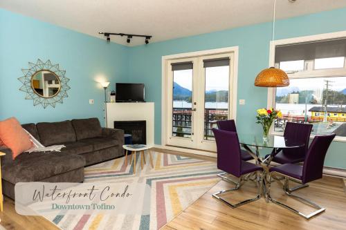 a living room with a couch and a table at Tofino Waterfront Condo in Tofino