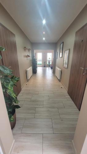 a hallway of a hospital with a tile floor at Fabryka Słodkości Mielno - 2 in Mielno