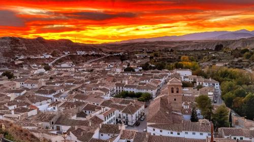 a view of a town with a sunset at La Petite Chaouen de Galera in Galera