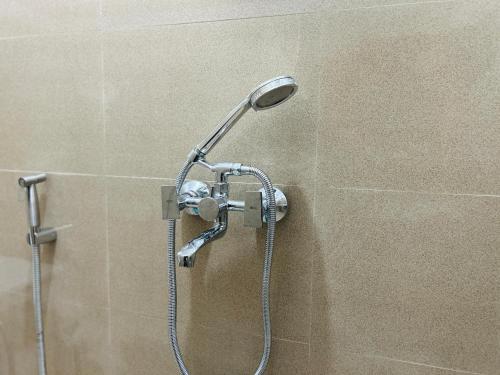 a shower with a shower head in a bathroom at Jetsunma Homestay in Darjeeling