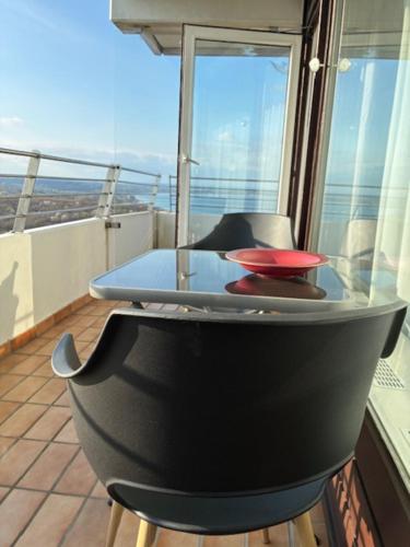 a table and chairs on a balcony with a view at Deck 29 in Timmendorfer Strand