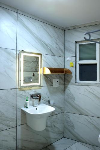 a bathroom with a sink and a mirror at ALPINE BNB Dharmshala Homestay in Dharamshala