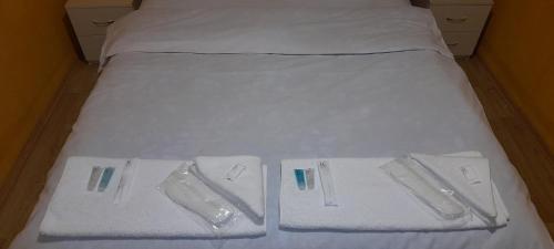 a bed with white towels on top of it at Baku Express Hostel in Baku