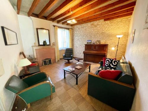 a living room with two couches and a piano at Charmant gîte familial en Touraine avec cheminée - FR-1-381-617 in Verneuil-le-Château
