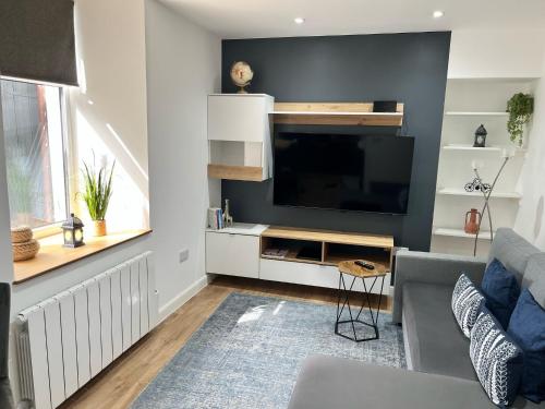 a living room with a large flat screen tv at 51 Innes Street Apartment in Inverness