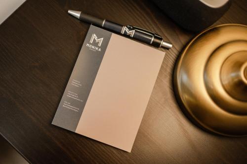 a pen sitting on a table next to a cup of coffee at Monika Apartment in Bogács