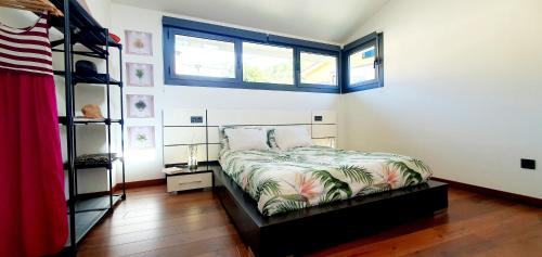a bedroom with a bed and a book shelf at La luz de Llanes in El Cueto